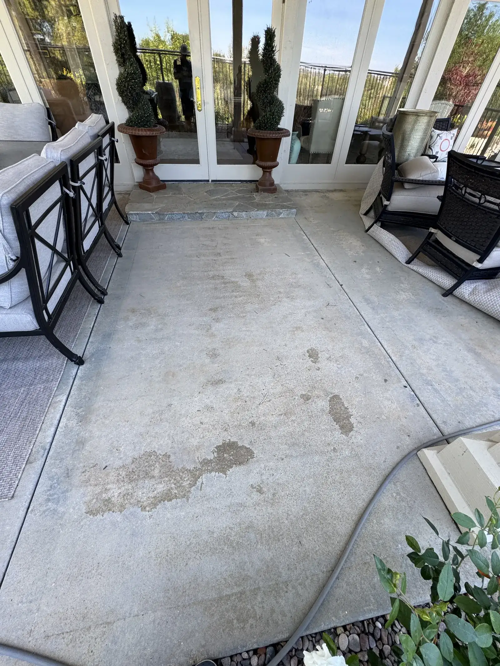 Concrete patio beside an outdoor seating area in a supplied cleaning photo