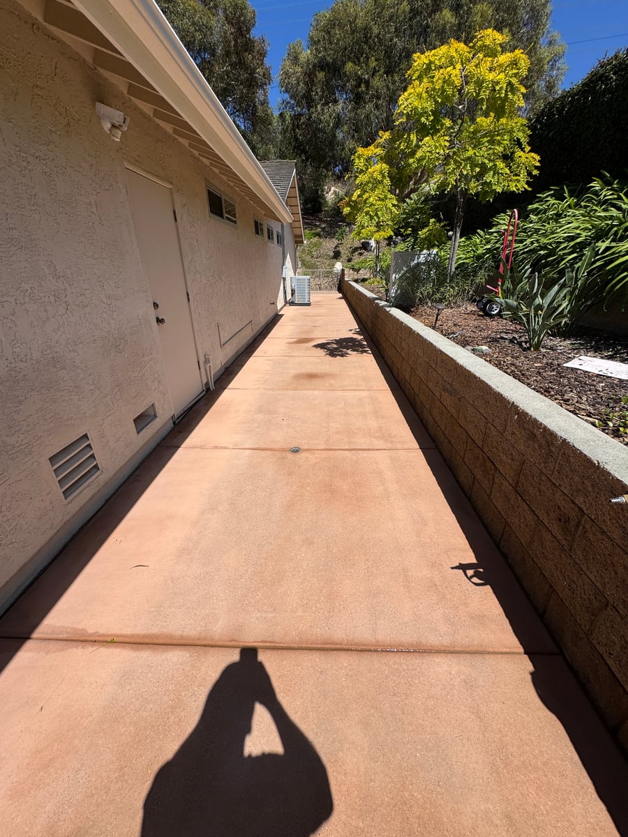 Pressure washing of concrete patio and brick bordered driveway