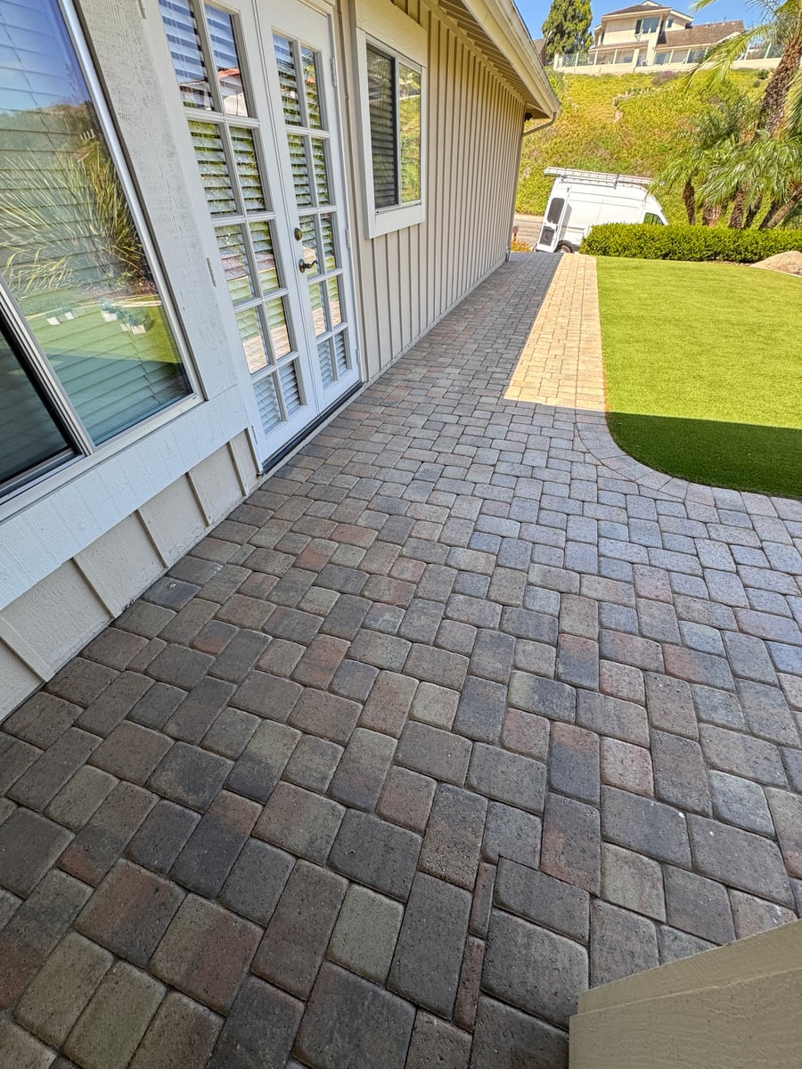 Pressure washing of concrete patio and brick bordered driveway